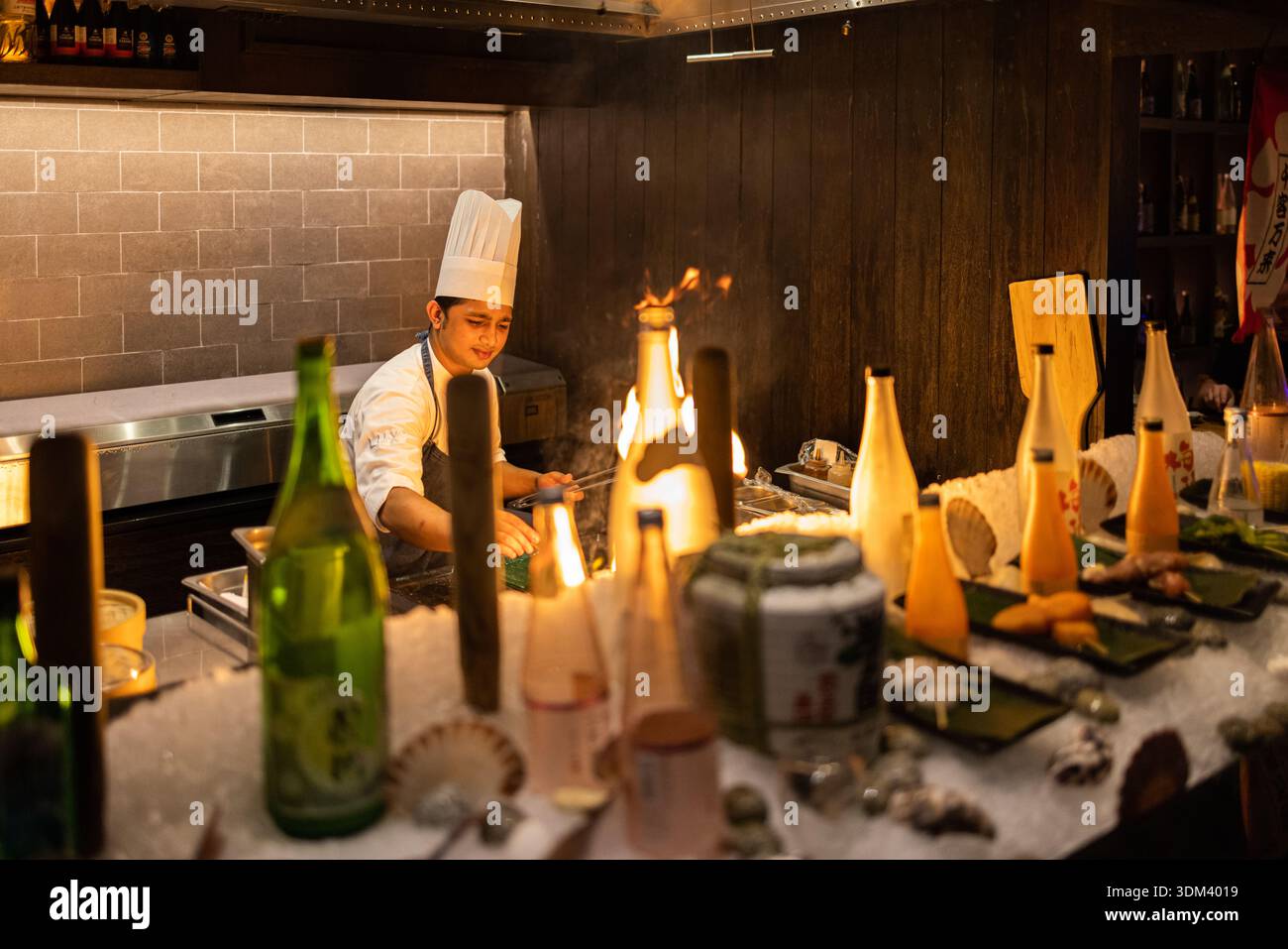 Live Asian kitchen chef cooking with fire dynamic restaurant culinary action food photography Stock Photo