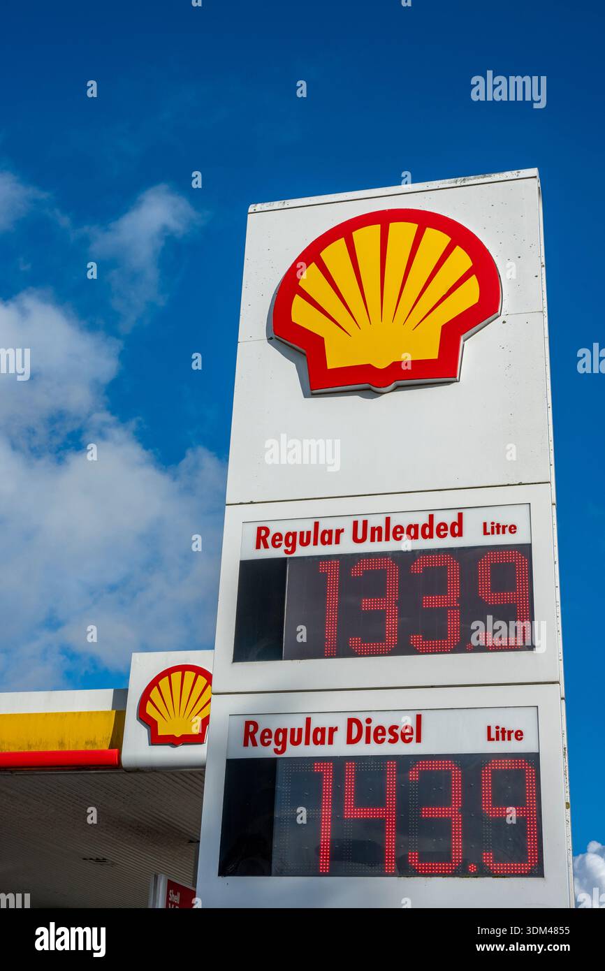 Shell garage pump prices with large Shell insignia or company logo on a ...