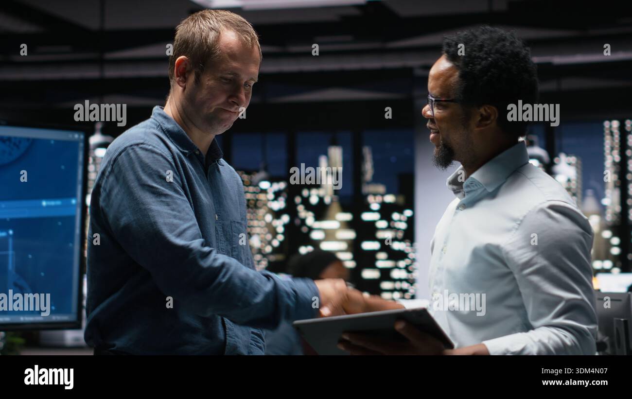 Programmers in office analyzing machine learning algorithms to prevent AI model errors. Colleagues reviewing code logic to improve artificial intelligence prediction accuracy Stock Photo