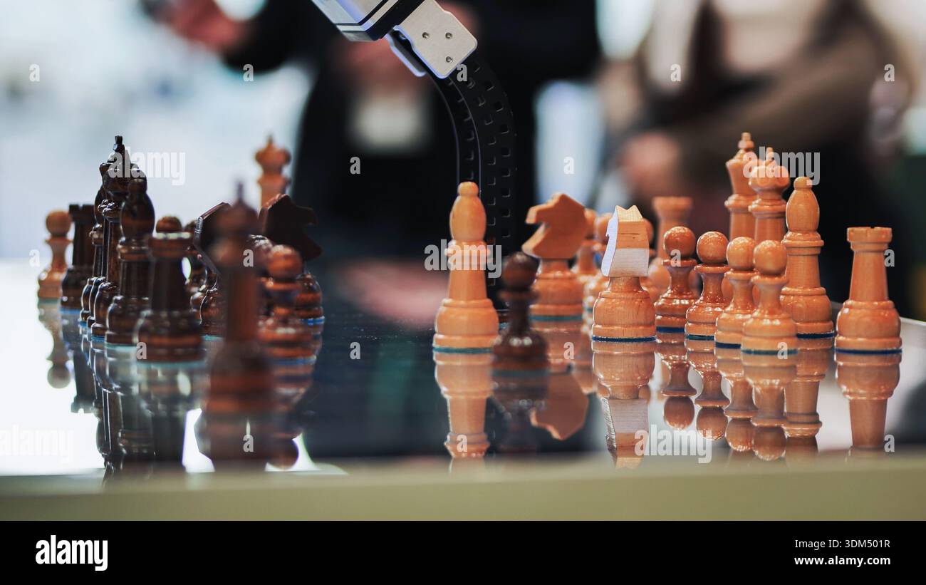 Robotic arm playing chess, demonstrating artificial intelligence and strategic thinking Stock Photo