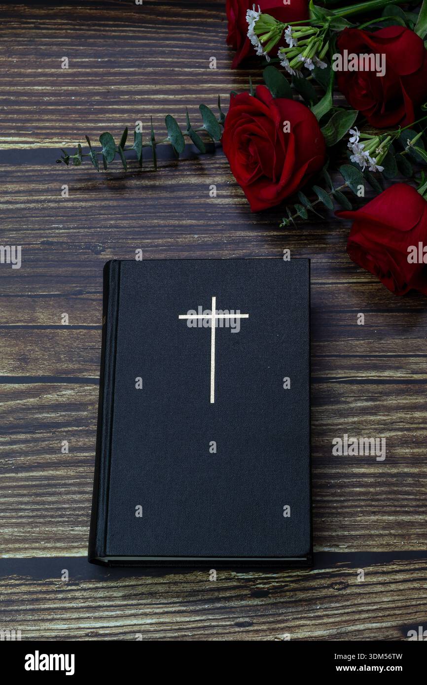 Holy Bible with cross and red roses on wooden background Stock Photo ...