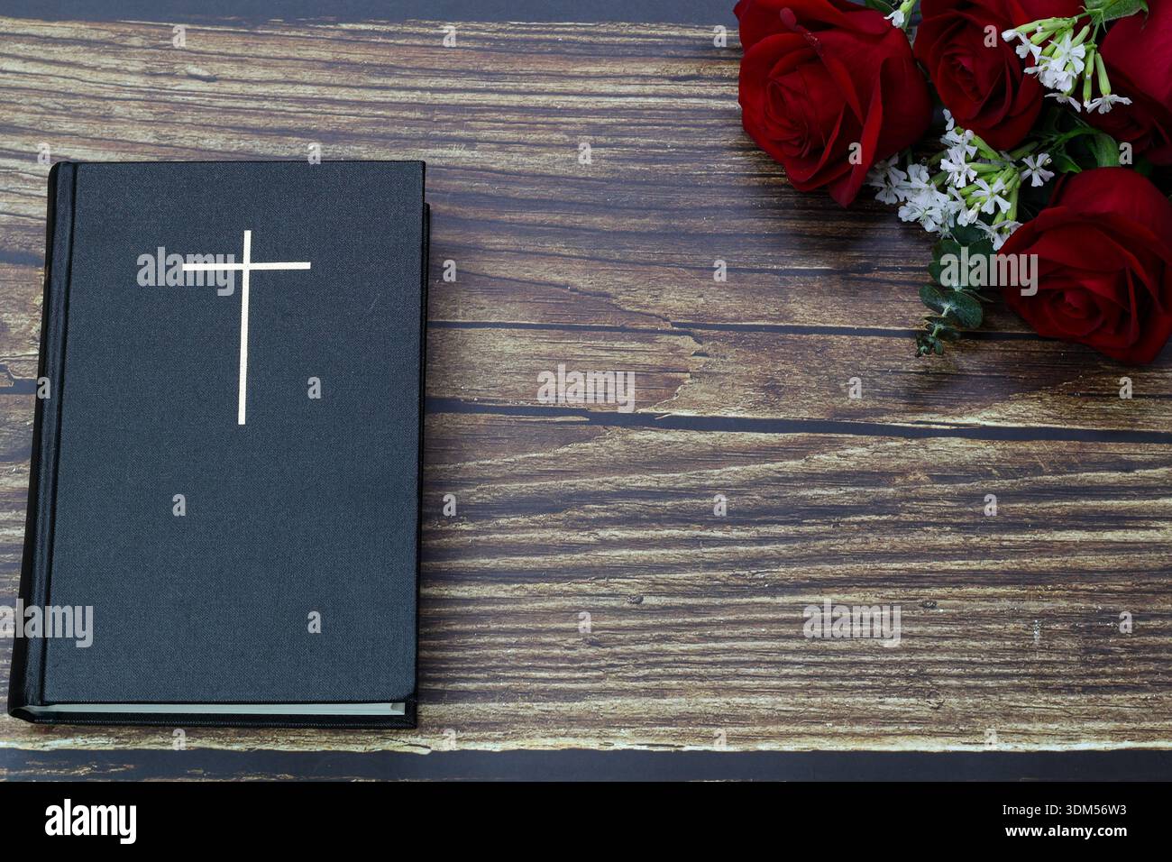 Holy Bible with cross and red roses on wooden background Stock Photo ...