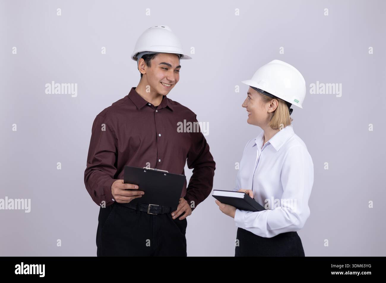 Male and female engineers discussing plan with tablet Stock Photo
