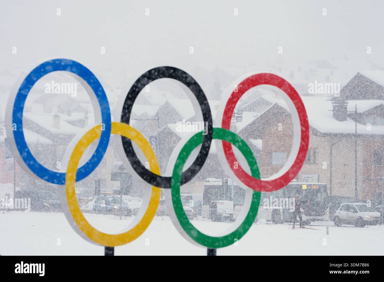 The Olympic rings stand as snow falls at the 2026 Winter Olympics, in ...