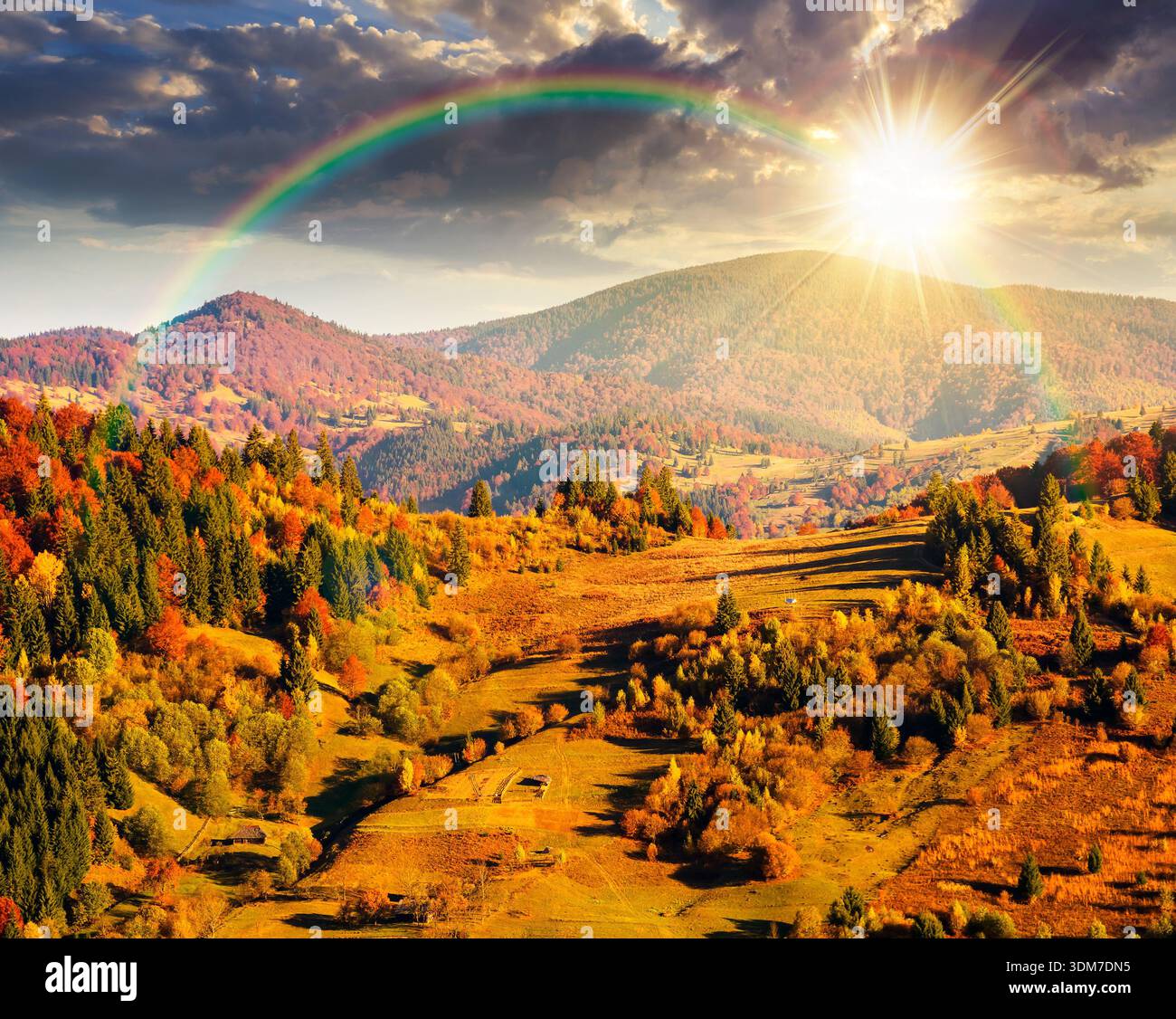 rural area in mountains autumn landscape at sunset. beautiful countryside scenery with rolling hills under blue sky in evening light. leadership corpo Stock Photo