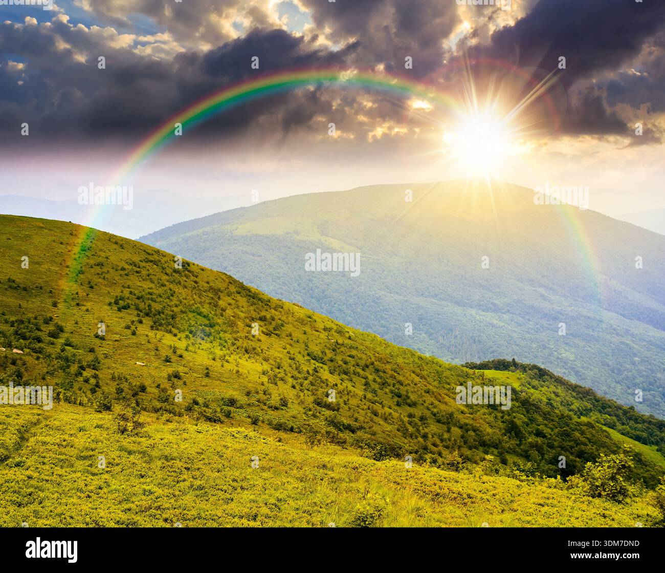 wonderful summer landscape of mountains in at sunset. scenic alpine view of rolling hills and green meadow in evening light. cloudy sky. storytelling Stock Photo