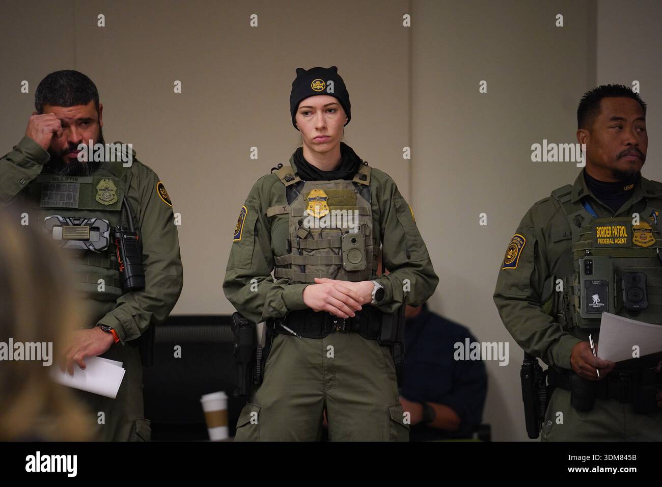 Federal agents look on as White House border czar Tom Homan holds a ...