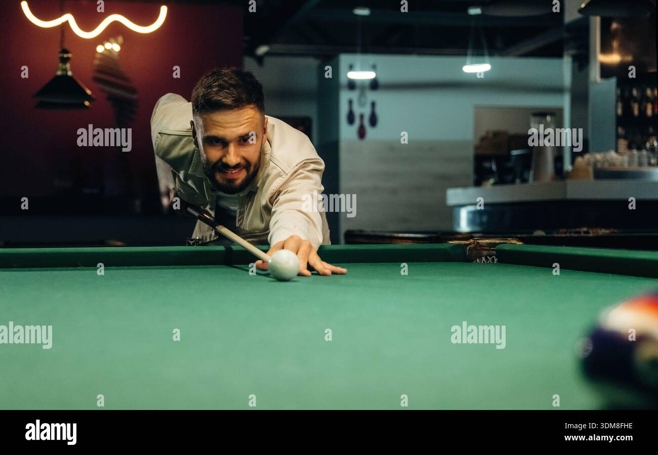 Focused, playing. Handsome man with a pool table game. Stock Photo