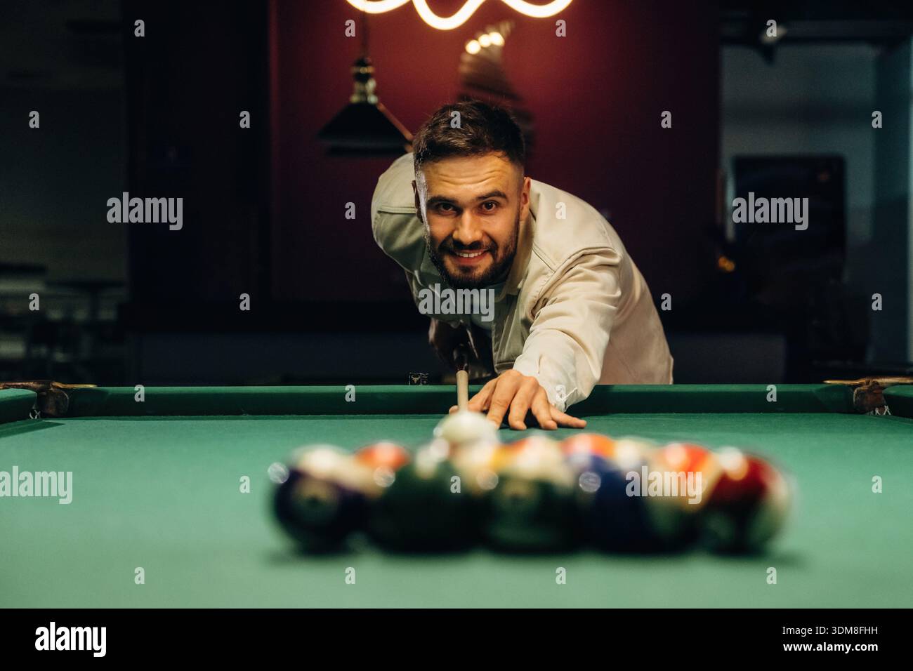 Focused, playing. Handsome man with a pool table game. Stock Photo