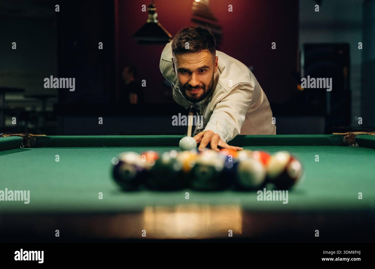 Focused, playing. Handsome man with a pool table game. Stock Photo
