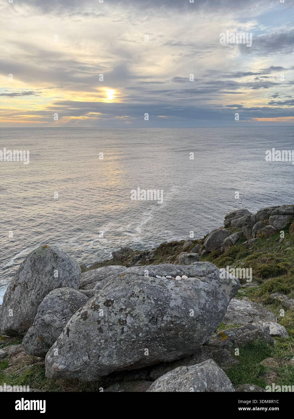 Sunset over the rocky coastline of Cape Fisterra, known as Fin do Mundo, on the Atlantic coast of Galicia, Spain. - Smartphone Captured Stock Image