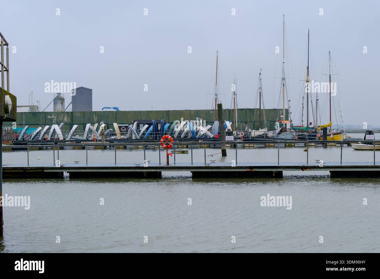 Brightlingsea, Essex, UK - 02 FEB 2025 - The dockside jetty and moorings  for dingys at an english harbour - Brightlingsea Stock Photo - Alamy