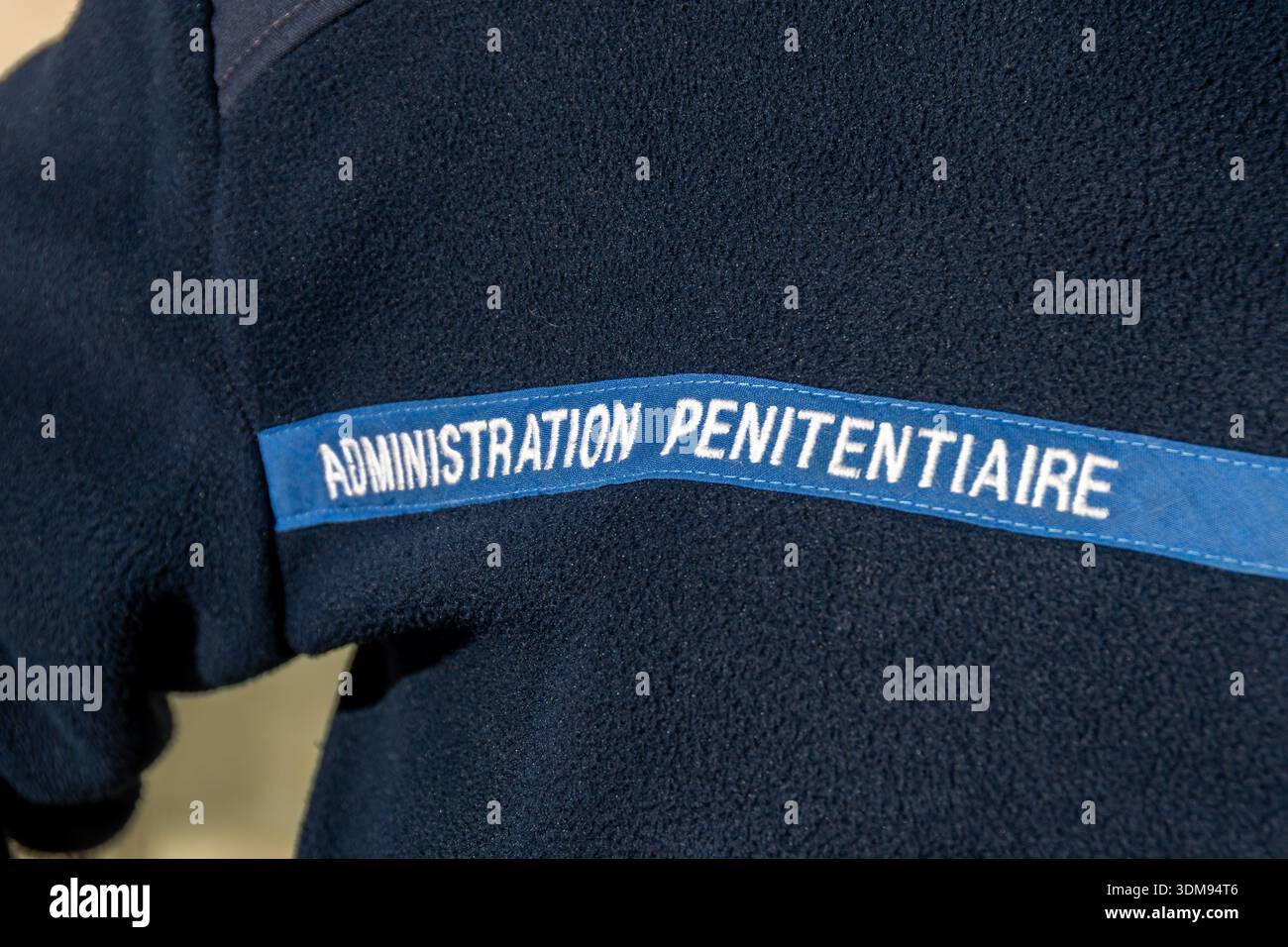 "Administration Penitentiaire" written in French on a gard's uniform. This administration is in charge of prisons in France Stock Photo