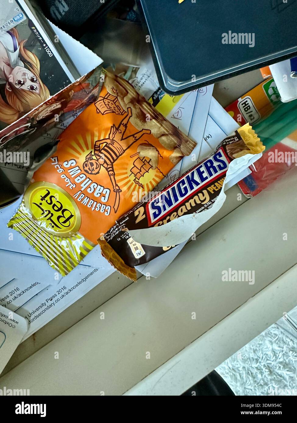 junk food snacks in teenagers bedroom - Smartphone Captured Stock Image