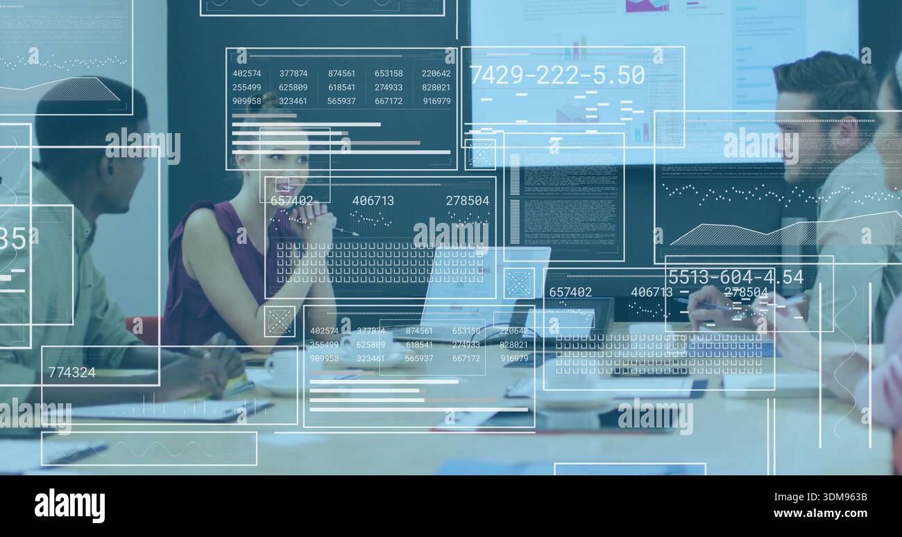 Discussing four staff in business attire reviewing data at meeting with ...
