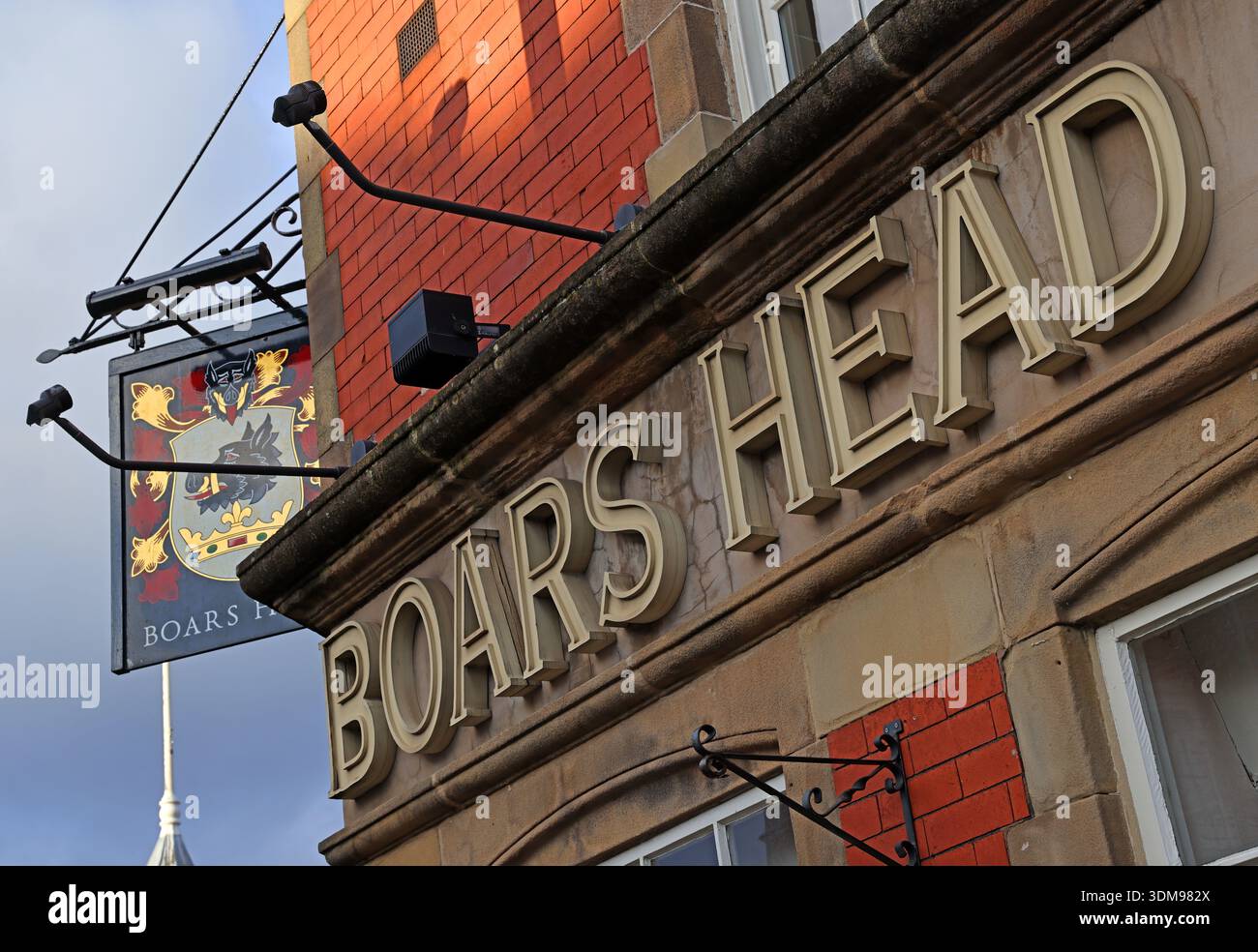 Close-up of “BOARS HEAD” lettering and hanging sign on the Boars Head public house at Market Place, 2 Vernon Street, Stockport, Greater Manchester Stock Photo