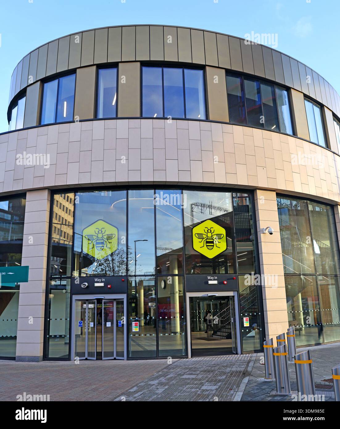 Pedestrian entrance to Stockport Interchange bus station with Bee Network branding on the glass frontage, Stockport, Greater Manchester, England, UK Stock Photo