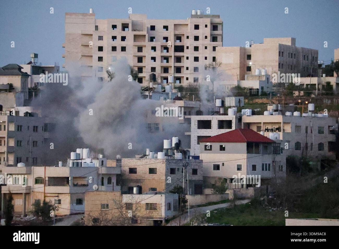 Smoke and dust ascend as the home of Palestinian Mahmud Abed, killed by ...