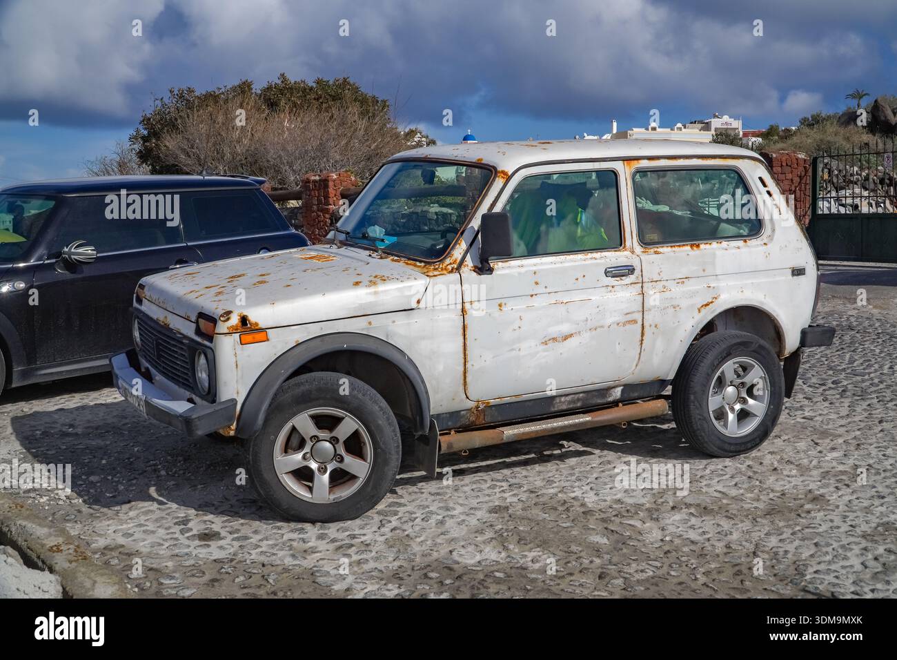 Rusted white Lada Niva abandoned outdoors