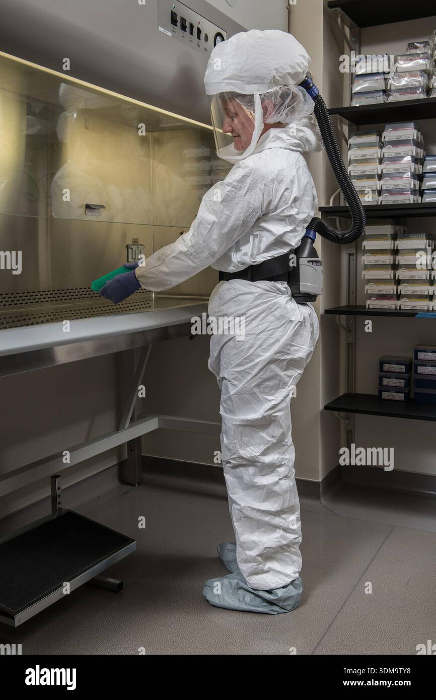 A Centers for Disease Control and Prevention (CDC) scientist prepares ...