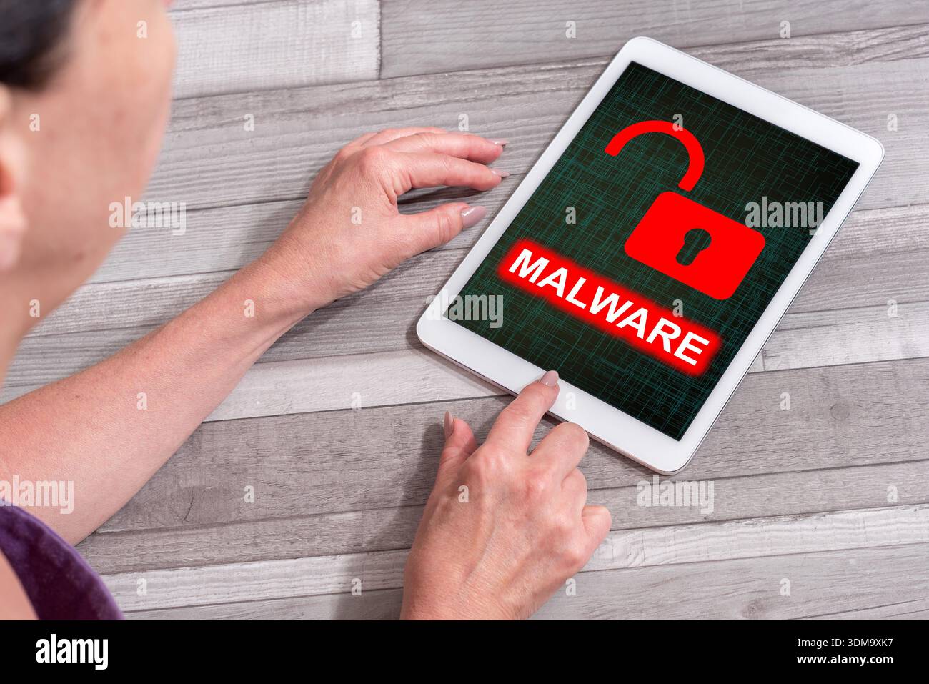 Woman using a tablet showing malware concept Stock Photo