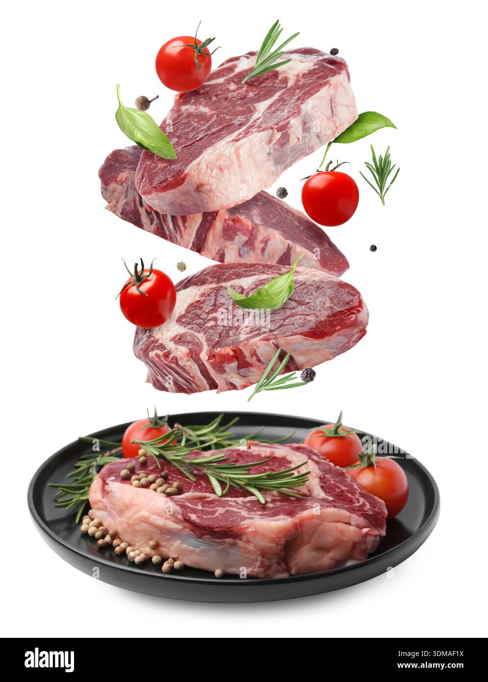 Fresh beef steaks falling on white background Stock Photo