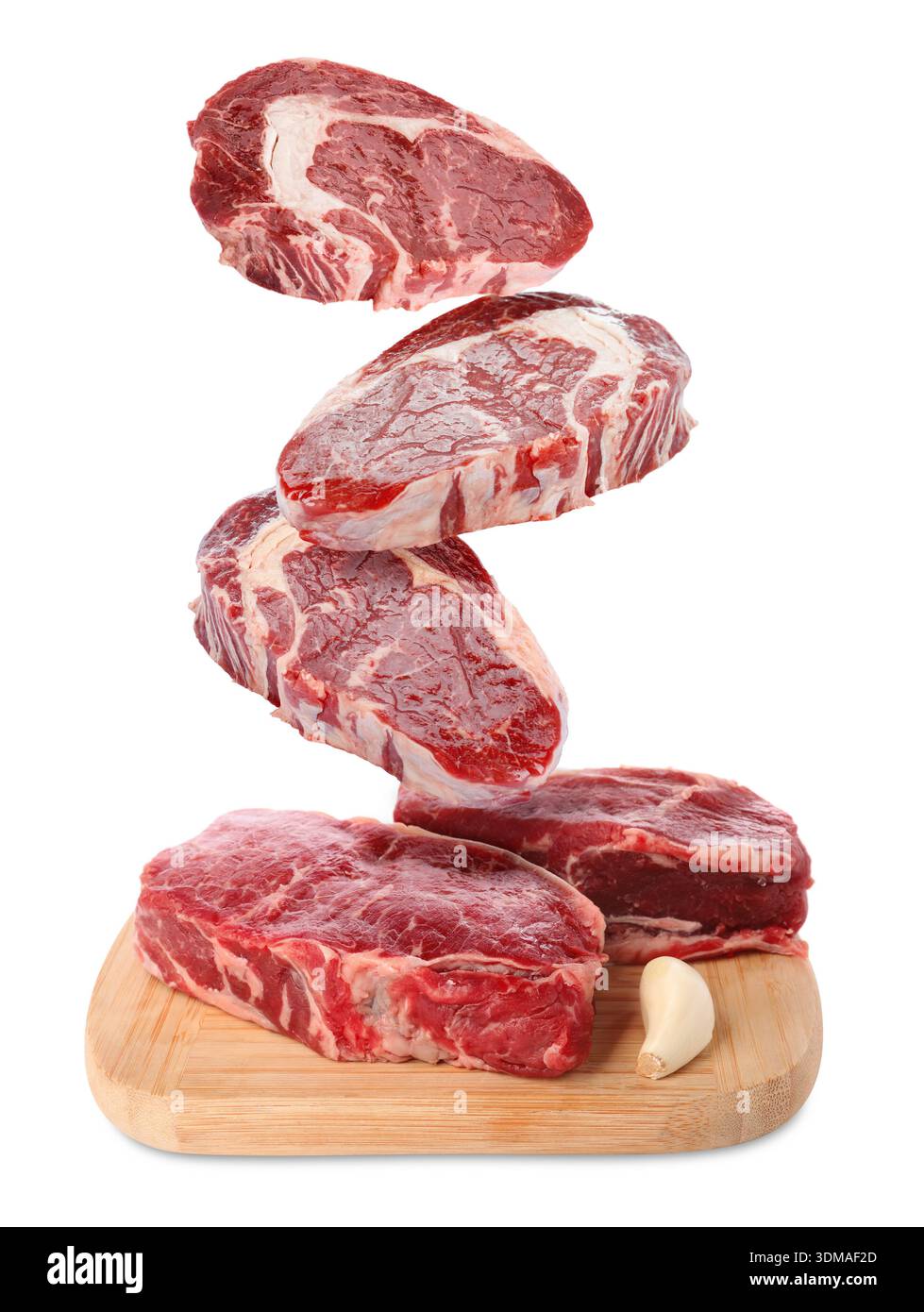 Fresh beef steaks falling on white background Stock Photo