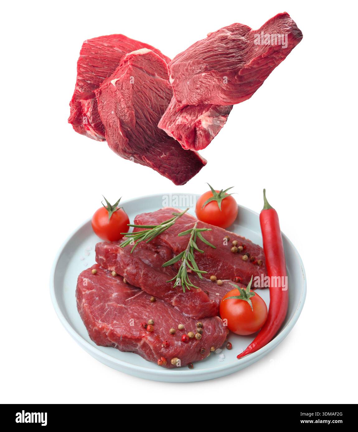 Fresh beef steaks falling on white background Stock Photo