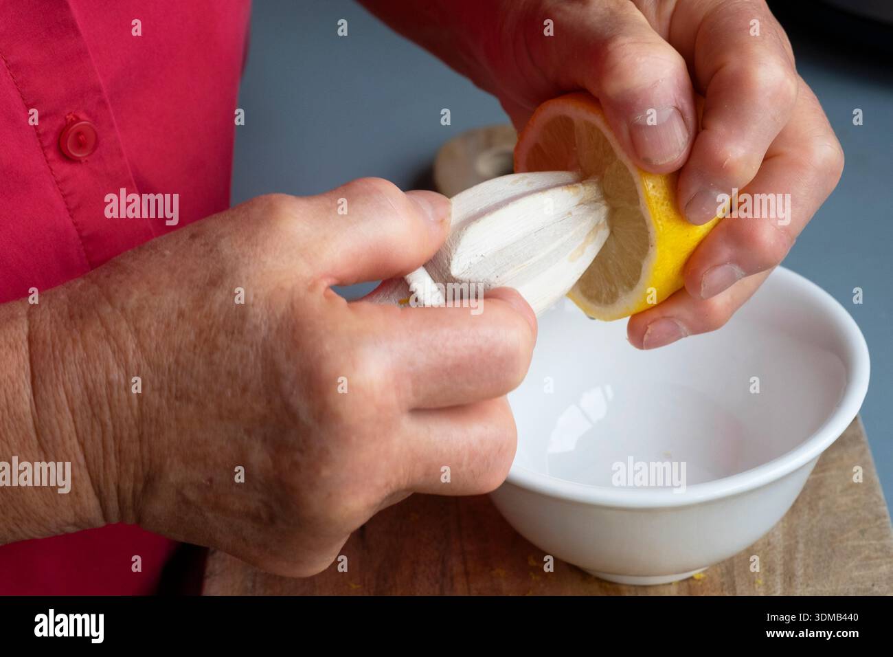 Cole-up of an elderly woman's arthritic hands performing kitchen chores Stock Photo