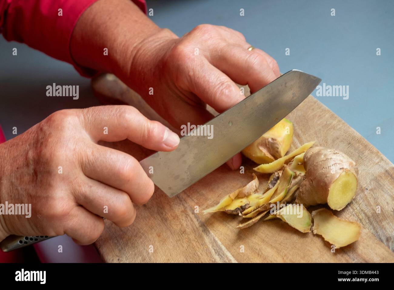 Cole-up of an elderly woman's arthritic hands performing kitchen chores Stock Photo