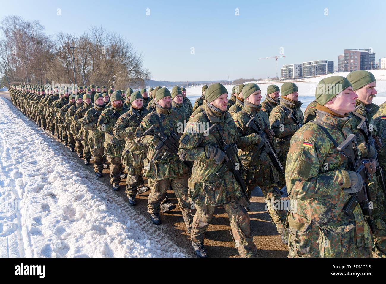 German soldiers in camouflage uniforms marching in formation on a snowy ...