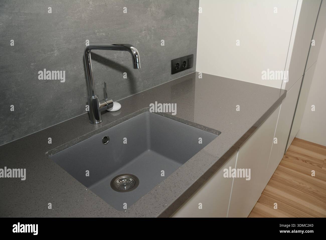 Kitchen faucet on a stylish ceramic sink Stock Photo