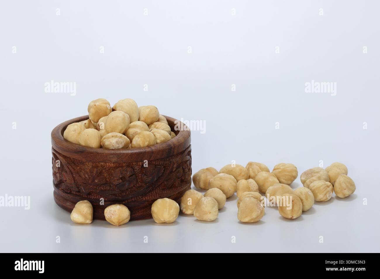 hazelnuts in a bowl on white background Stock Photo