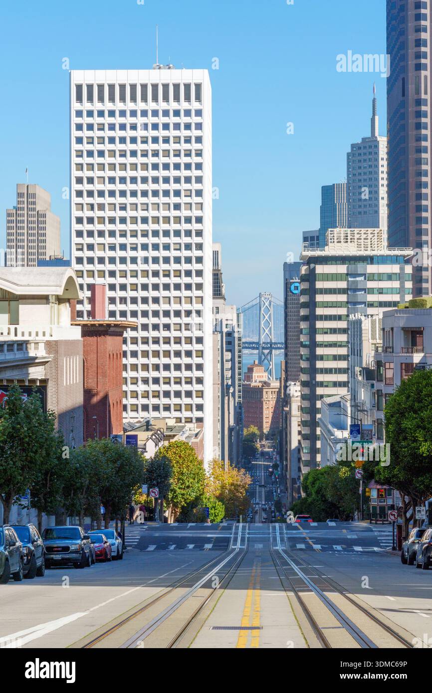 View along California Street with the San FranciscoCOakland Bay Bridge in the distance, San Francisco, California, USA. Stock Photo
