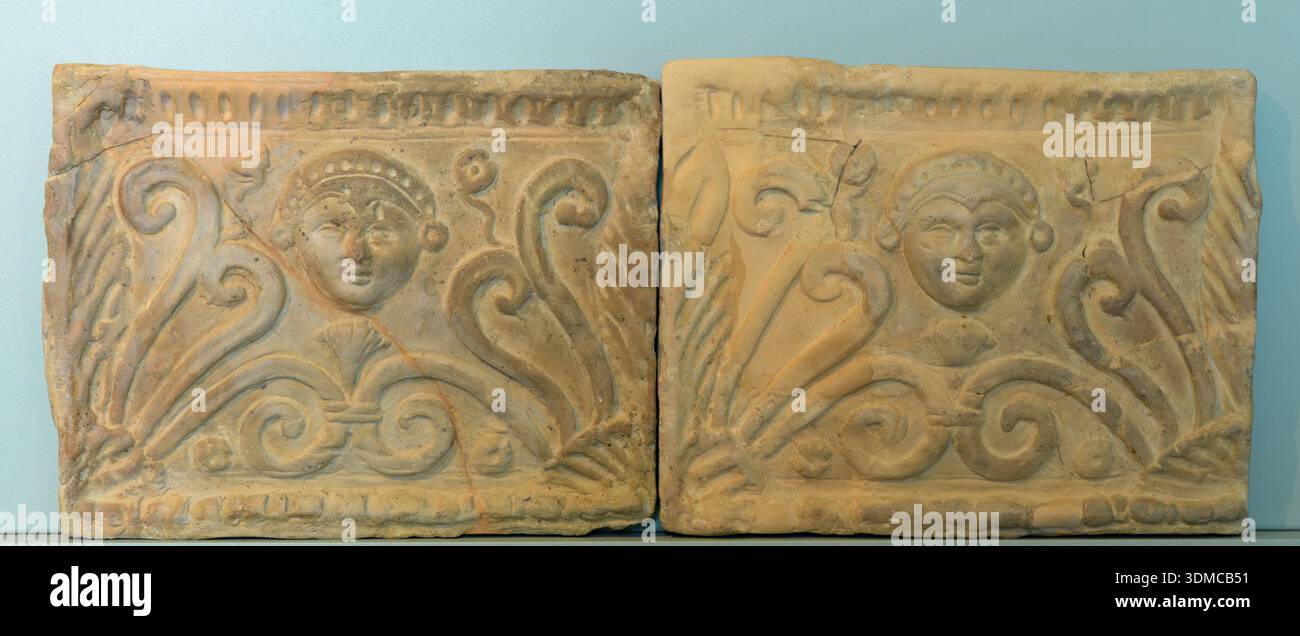 Two ancient terracotta architectural plaques featuring a relief face ...