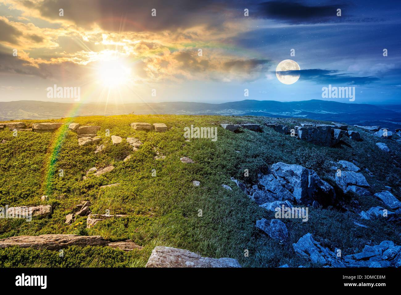 grassy alpine meadow in carpathian mountain landscape on summer solstice. day and night time change concept. sharp rocks and huge boulders among grass Stock Photo