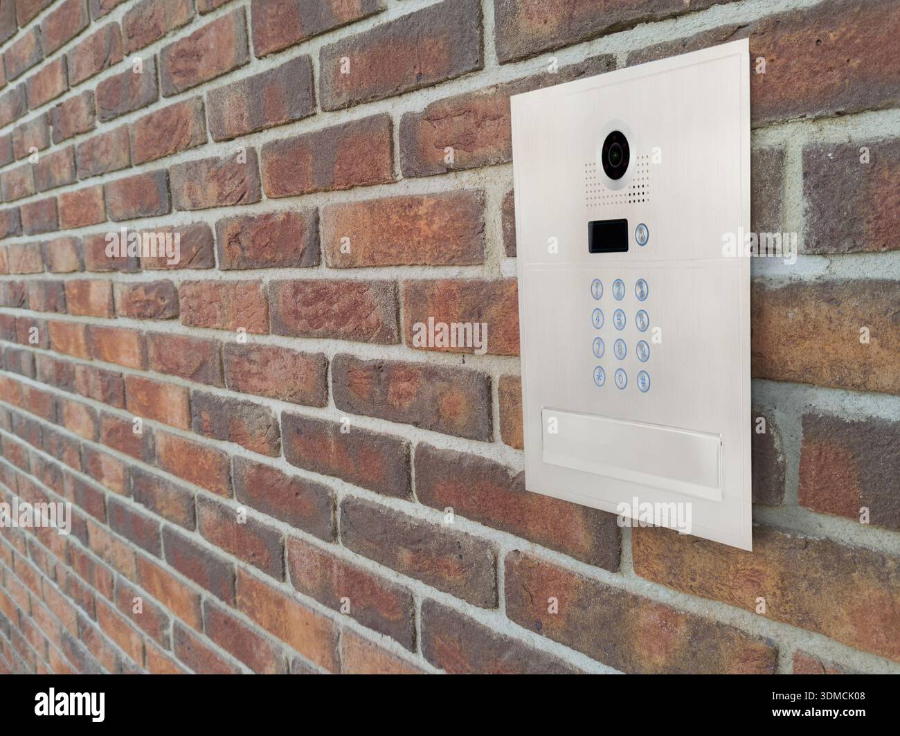 Modern Video Intercom Mounted on Brick Wall Stock Photo