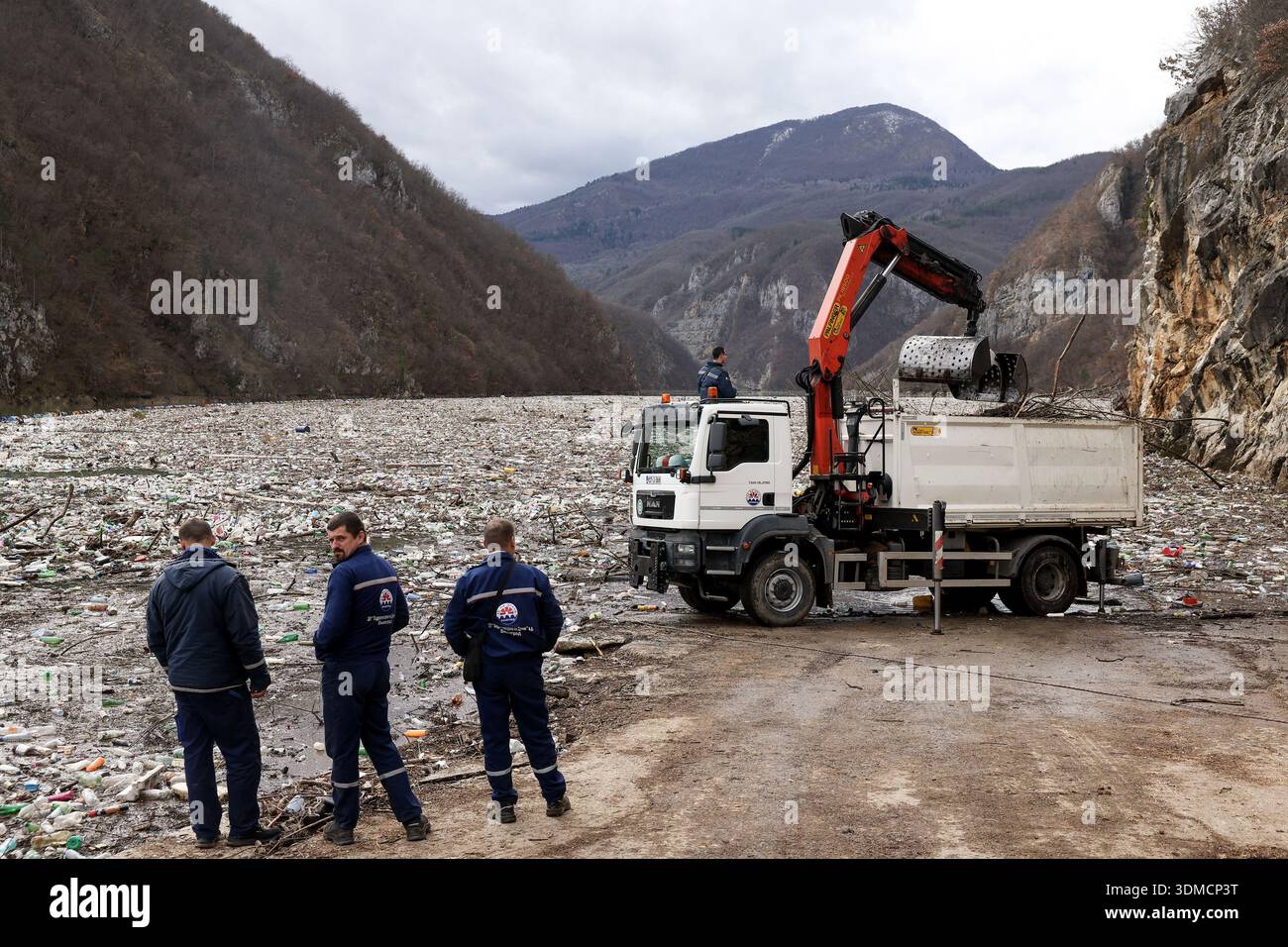 Clogging Rivers Workers use a crane to remove waste clogging the Drina river in ...