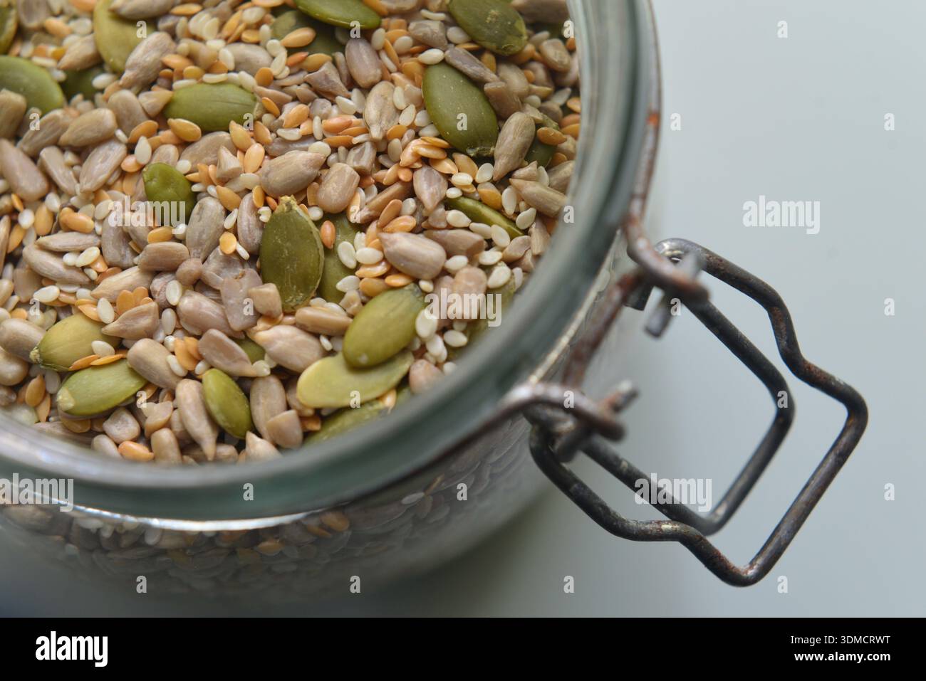 Healthy nutritious mixed seeds fresh natural whole food in glass jar Stock Photo