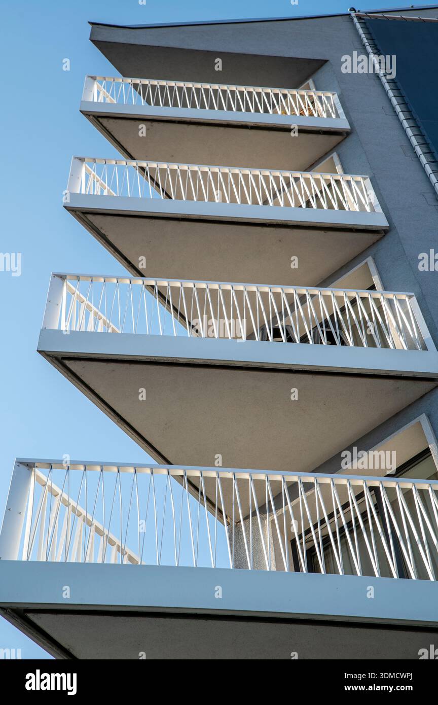 Triangle shaped balcony with white metal railings on a modern building ...