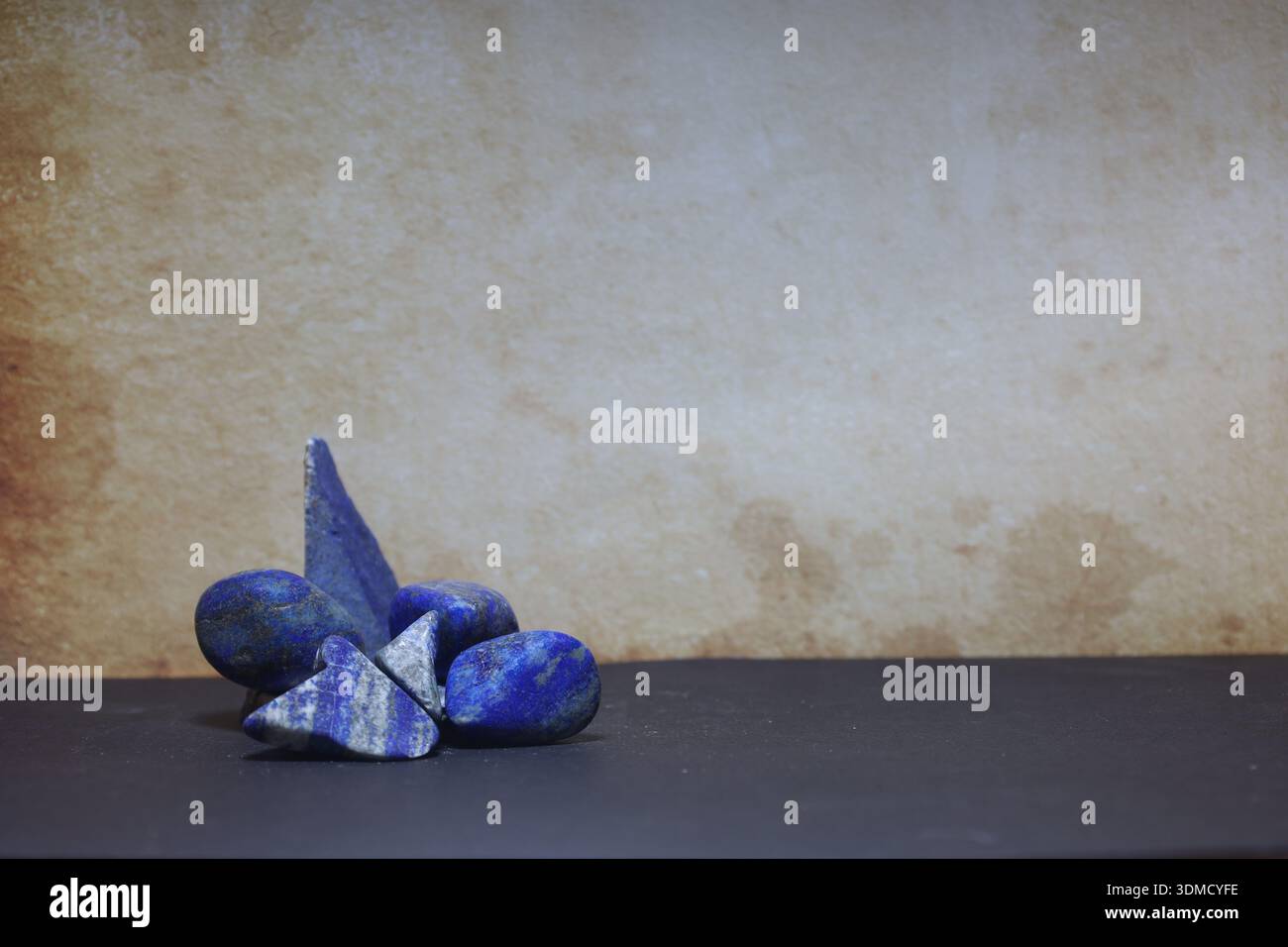 Assorted lapis lazuli stones showcasing natural patterns and textures, perfect for gem-related or spiritual imagery Stock Photo