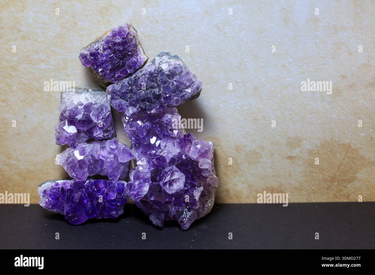 Several natural amethyst crystal clusters arranged in a vertical, balanced composition. Stock Photo