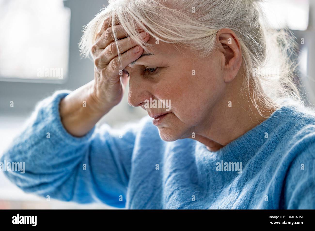Senior woman suffering from headache Stock Photo