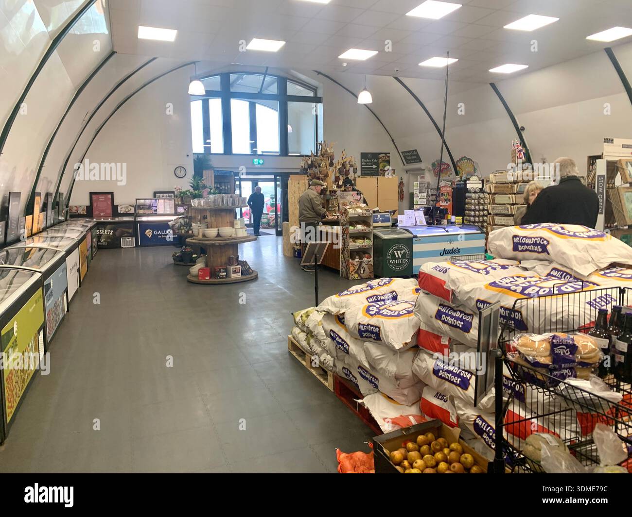 Farm shop called Whites Earls Barton Northamptonshire England British English customers browsing fresh products displayed on shelves of local goods - Smartphone Captured Stock Image