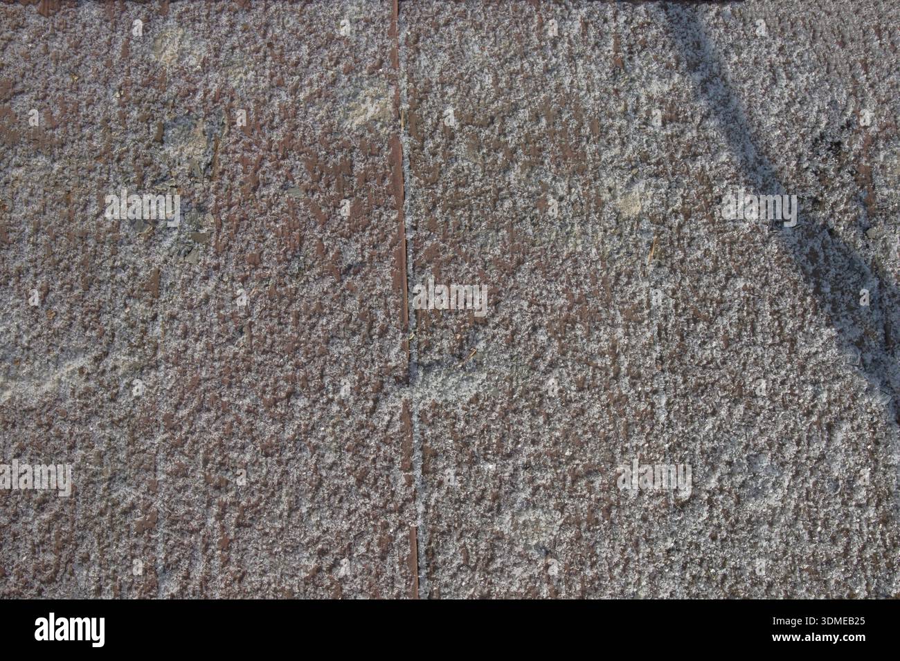 Frost covered concrete pavement texture with visible joints and rough surface Stock Photo