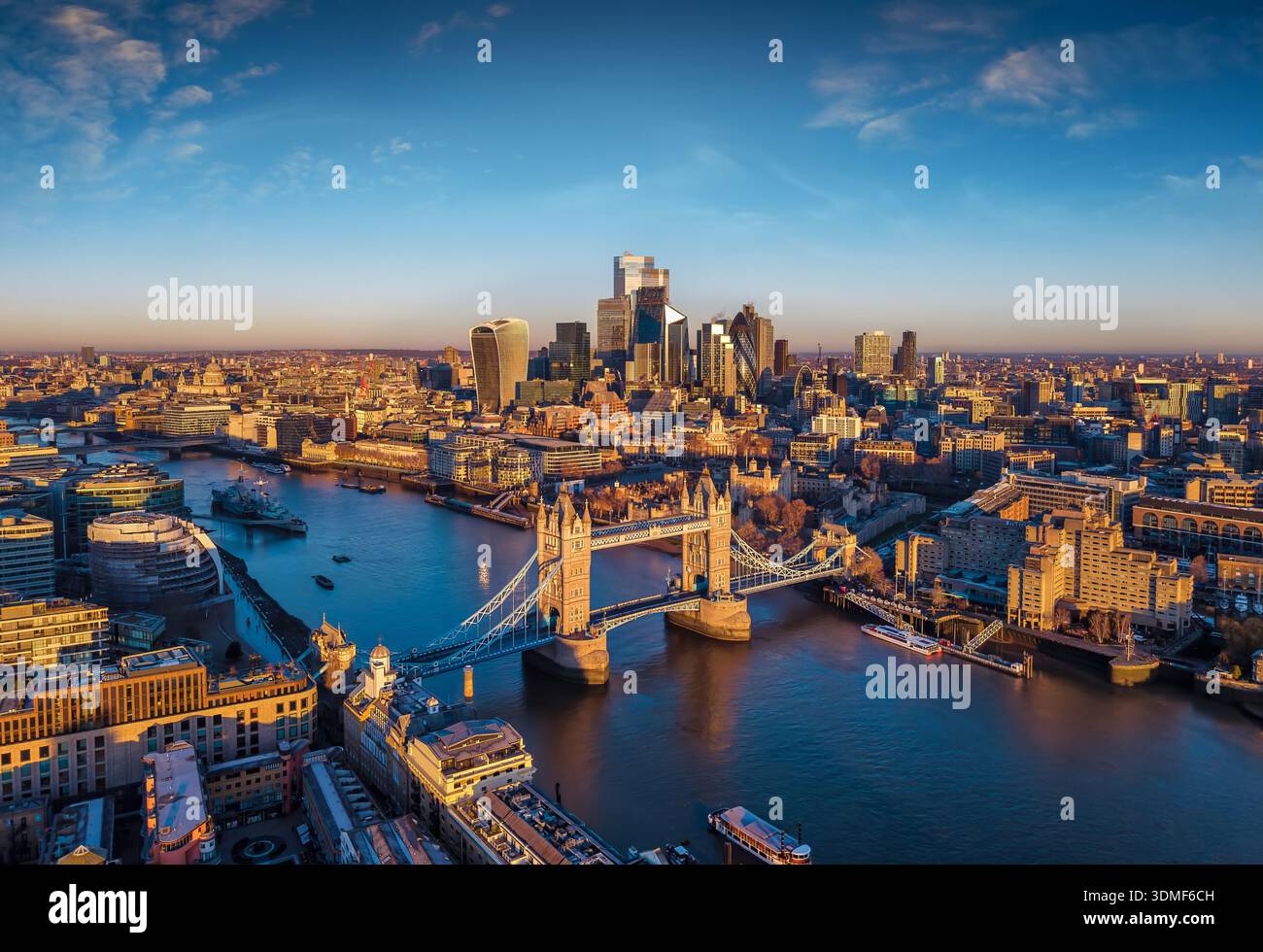 Aerial sunrise view of the isconic landmark Tower Bridge and City of London, UK, in golden sunlight Stock Photo