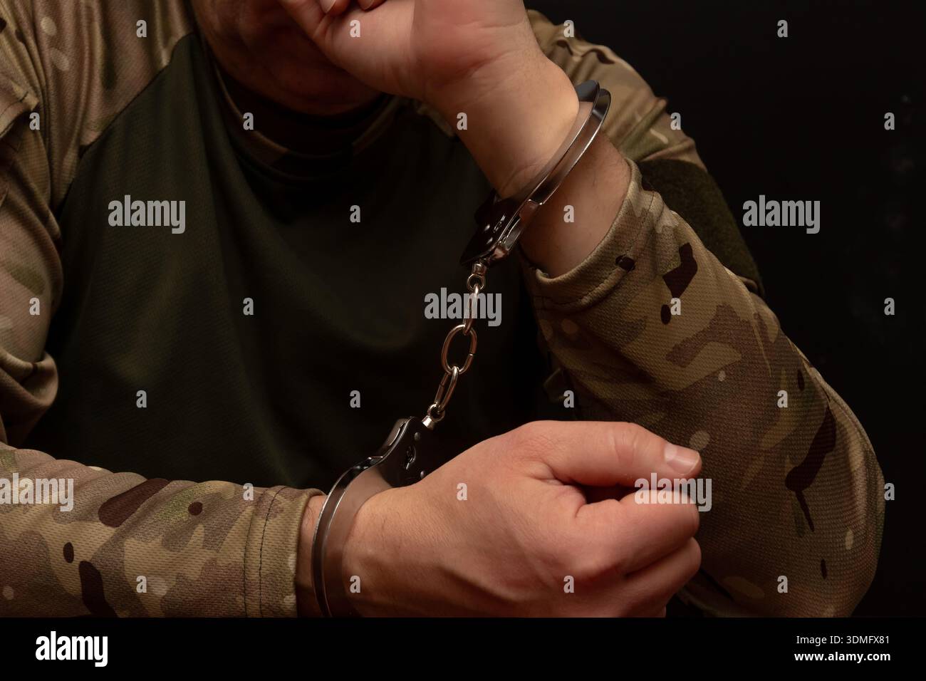 Soldier in handcuffs as symbol of war crimes. Stock Photo
