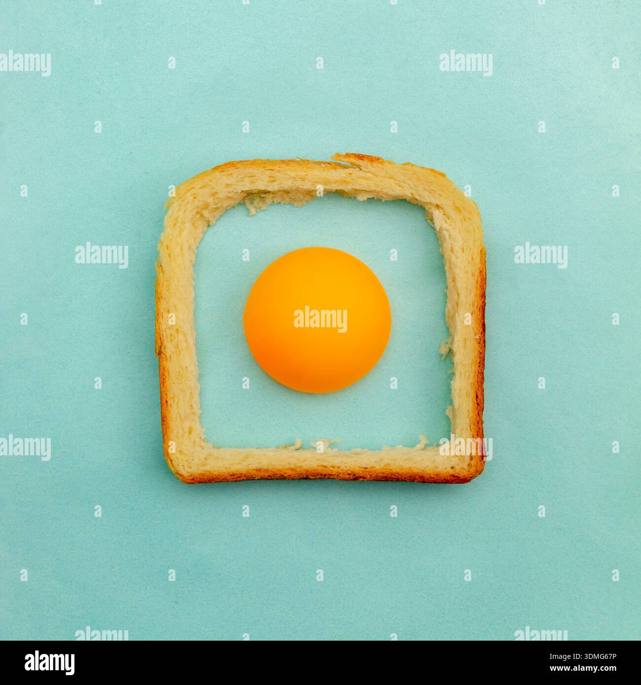 Eggs made of a ping pong ball and a crust bread of toast pastel blue background. Easter concept Stock Photo