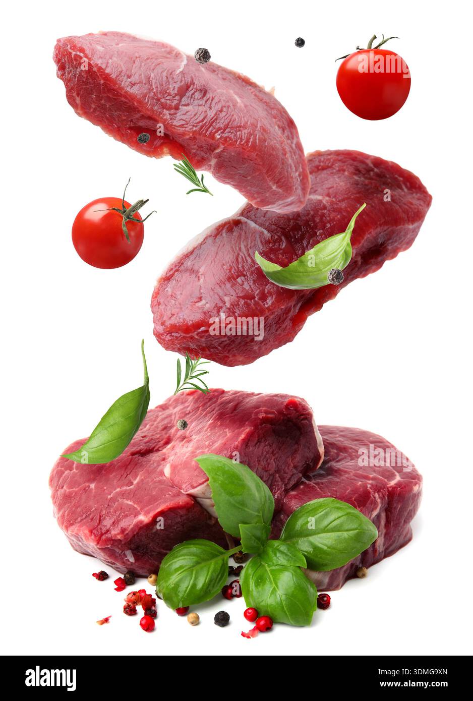 Fresh beef steaks falling on white background Stock Photo