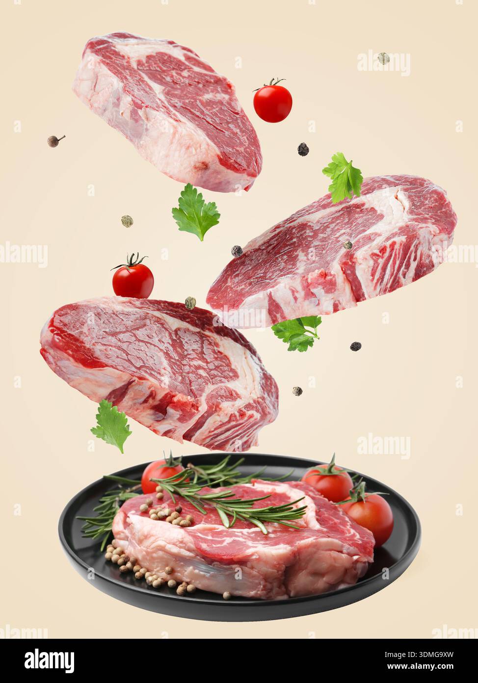 Fresh beef steaks falling on beige background Stock Photo